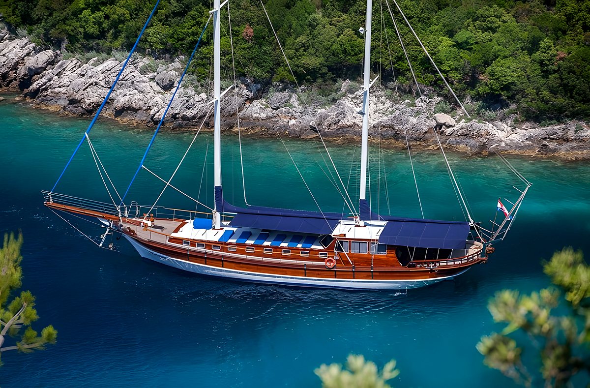 A gulet anchored in a turquoise cove on a boat tour