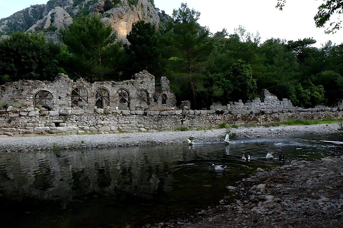 Ruins of Olympos Ancient City by the stream, with the Taurus Mountains behind