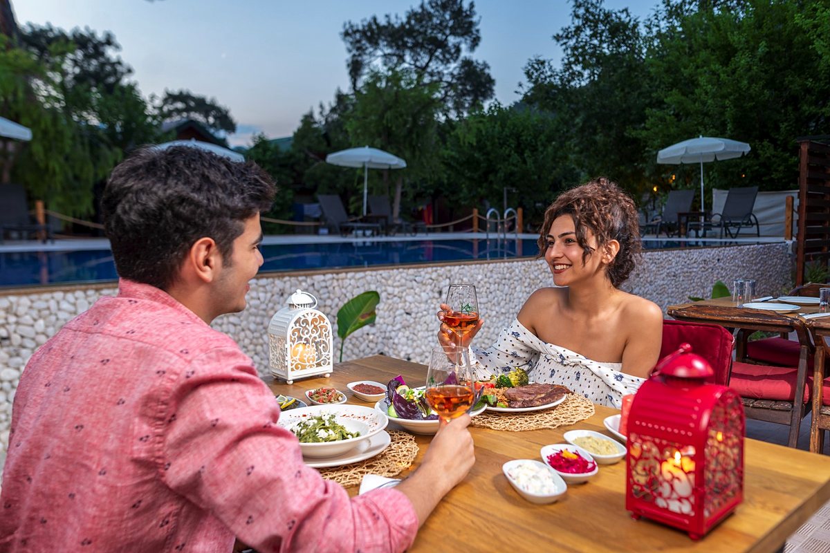 A couple having dinner by the pool