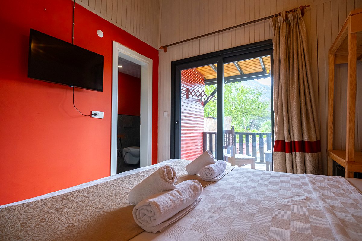 Teras Bungalow: kırmızı duvar, televizyon ve yatak